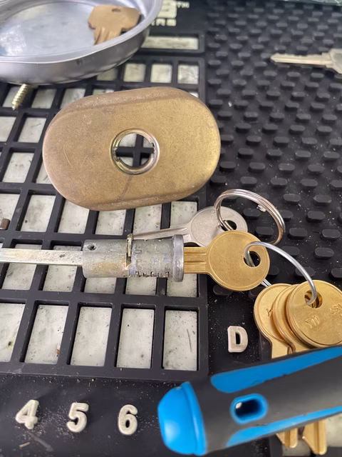 Storm door lock cylinder rekey
